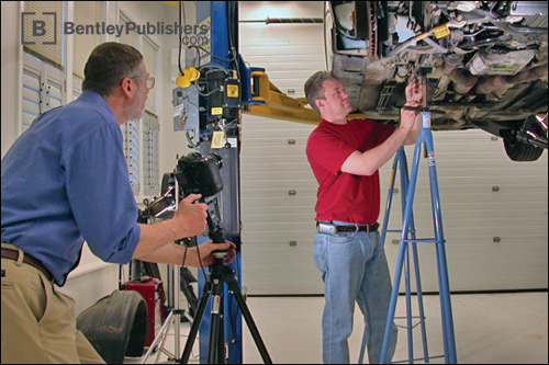 Bentley technical editors documenting fuel filter replacement.